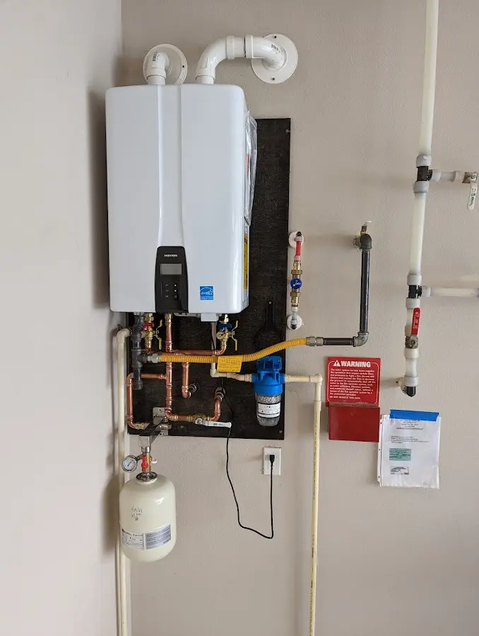 Professional plumber installing copper piping in a Applewood home